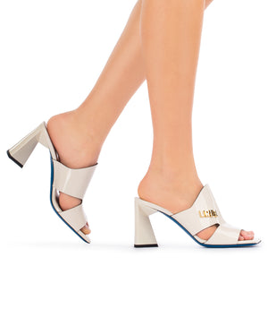 Mules in vernice panna con placca-logo